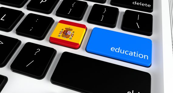 Computer keyboard with word Education and Spanish Flag, selected focus on enter button.